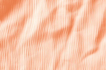 Elegant orange textile background. Silk cloth texture. Fabric pattern.
