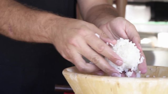 Chef hands preparing fresh maki sushi