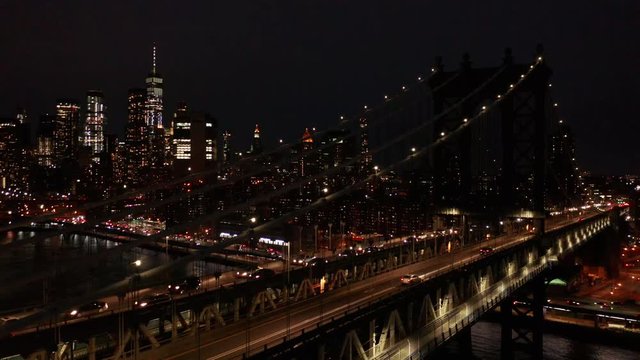 night flying next to Manhattan Bridge revealing downtown NYC