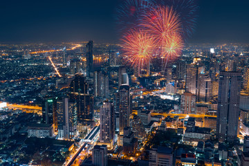 Bangkok cityscape with fireworks in the business district at night.