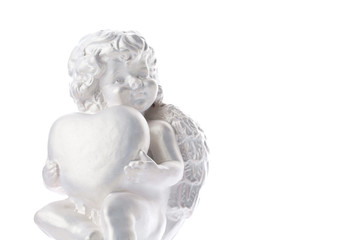 Cherub statue isolated on white background. Angel holds the heart. Love