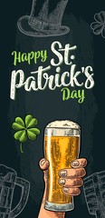 Male hand holding beer glass. Happy Saint Patrick's Day calligraphy lettering.