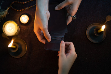 Gypsy fortune tellers are predicting horoscopes for customers using predictive gypsy cards.