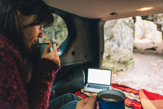 Couple Laying In Suv Car Trunk With View Of Rocky Mountains