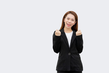 Happy asian business woman arms up in black suit isolated on white color background