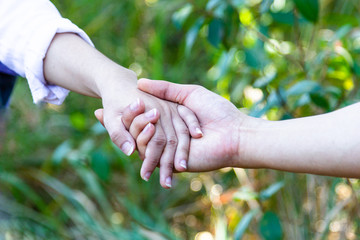 Close up Couples holding hands.