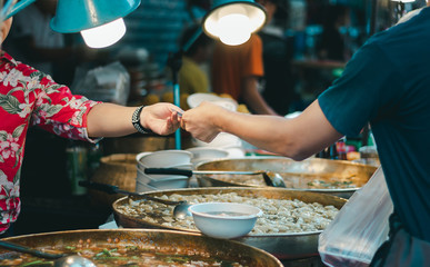 People buy street food at night market