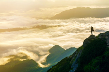 Wide mountain panorama. Small silhouette of tourist with backpack on rocky mountain slope with...