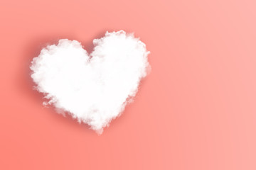 White cloud in the shape of a heart with soft shadow against living coral color background. Concept of love and feelings