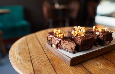 Four slices of chocolate cake sitting on a bakery table