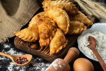 Homemade pies with cabbage on a wooden rustic  table.