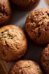 Freshly baked muffins cooling on a serving board