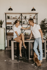 Beautiful loving couple laughing and hugging in the kitchen
