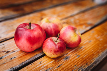 Sweet red apples on a wooden background