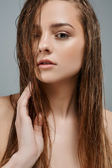 Beautiful portrait of a girl with wet make-up and shiny skin. Perfect Fresh Skin. Pure Beauty Model. Youth and Skin Care Concept