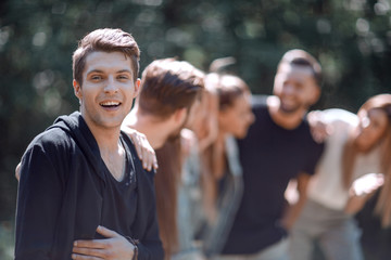 successful guy in the background of friends