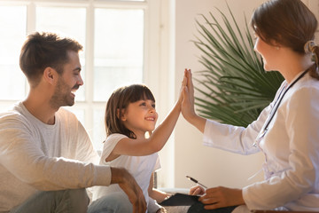 Healthy child girl giving high five to doctor celebrate recovery