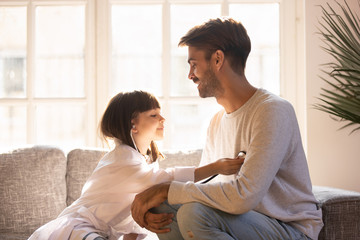 Little daughter playing game as doctor having fun with dad