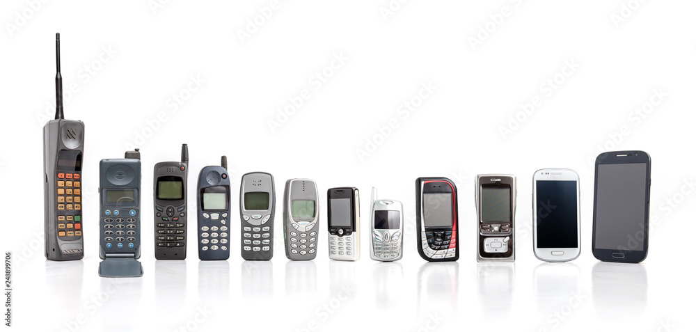 Wall mural old mobile phone from past to present on white background.