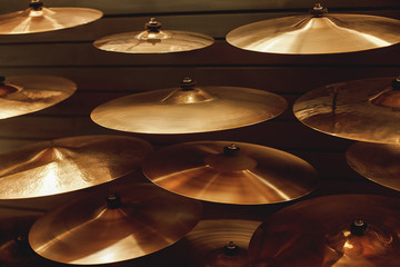 Visiting musical instrument store. Different types of drum cymbals for your ideal drum set. Music...