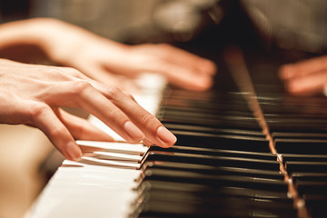 Beautiful Piano Melody...Close up view of female hands playing on piano her favorite classical music © Friends Stock
