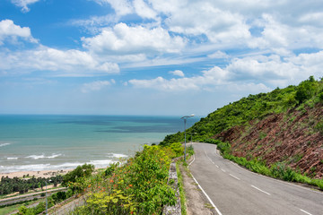 top view of sea beach road looking awesome from top of a mountain with blue sky & beautiful sea view.