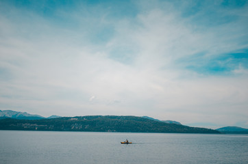 A single kayak in the middle of a lake.