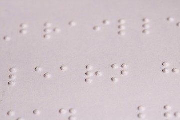 Fototapeta na wymiar Close up of tiny braille dots read by visually impaired readers.