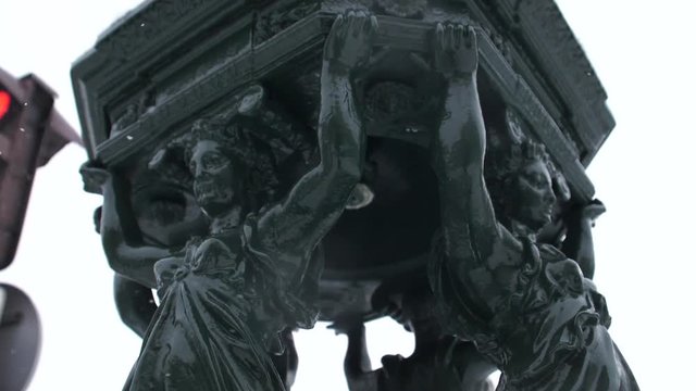 Fountain in Paris, France in a snowy day