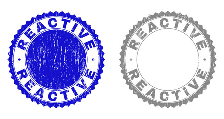 Grunge REACTIVE stamp seals isolated on a white background. Rosette seals with distress texture in blue and grey colors. Vector rubber stamp imitation of REACTIVE tag inside round rosette.