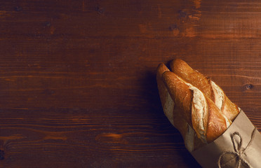french baguette in a rustic style on a wooden table