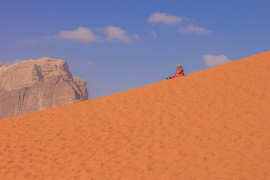 daily planet travel concept photography with resting sitting old woman in vivid colorful Middle East desert outdoor scenic landscape environment and empty copy space for text or inscription