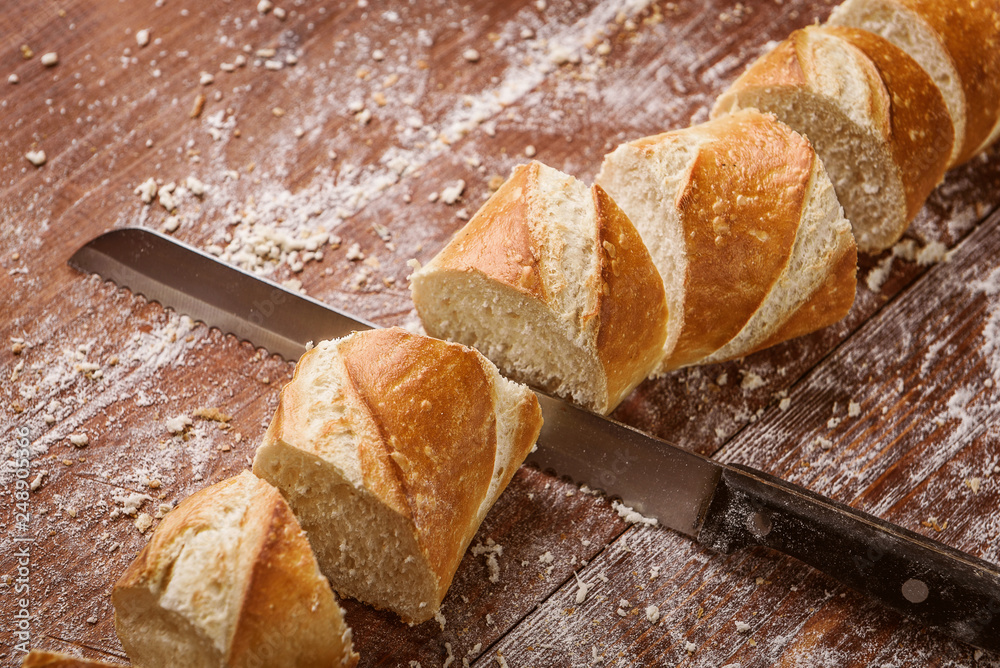 Poster sliced bread on a wooden table. fresh baking concept