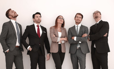 Happy positive business group looking up with dreaming expression