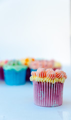 Homemade, colorful cupcakes on white background