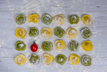 Fototapeta na wymiar Homemade fresh Italian ravioli pasta on white wood table background,top view.
