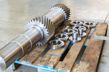 New shaft gear on a rack after production.