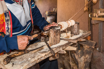 Peruvian man at handmade lathe machine