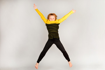 Fototapeta premium The girl jumps up, arms and legs in different directions.