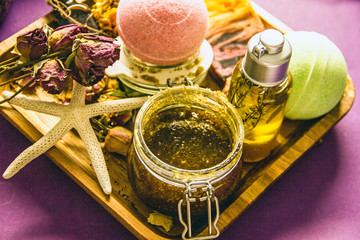 Home cosmetics on herbs and essential oils, bath bombs, fragrant body oil, bottle of essential oil, dried flowers, handmade soap, fragrant bath salt, body scrub. Homemade spa, handmade cosmetics