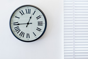 A wall clock on the white background