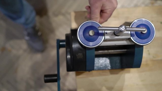 Jeweler makes a piece of jewelry - golden wedding ring