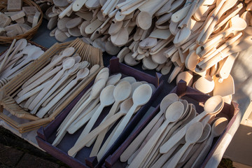 Handmade wooden kitchen utensils, selling on street market. Spoons, honey dippers, mixing spoons, for spices.