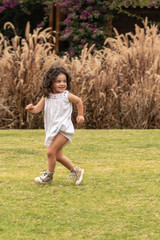 Beautiful girl trying to escape in a playful way. Hide and seek game in a candid portrait