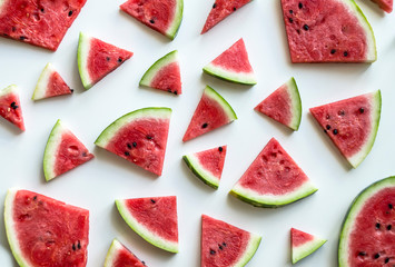 Creative scheme of sliced ​​watermelon on a white background. Watermelon, isolated on white background. View from above. Background with watermelons