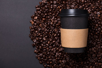 Take away black coffee cup with roasted coffee beans