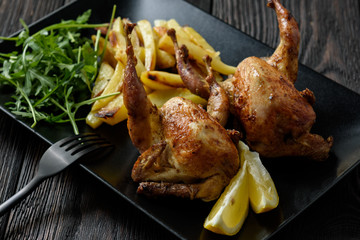 Grilled quails with fried potatoes and tomato dip.