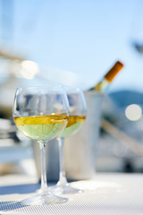 Pair of wineglasses against the yacht