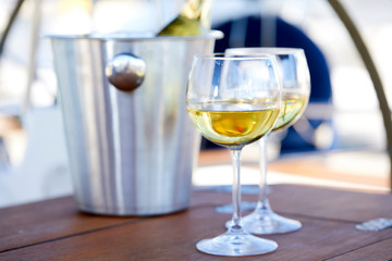 Pair of wineglasses against the yacht