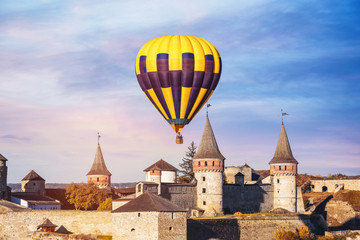 Fototapeta na wymiar KAMIANETS-PODILSKYI, UKRAINE - OCTOBER 06, 2018: Beautiful view of hot air balloon flying near Kamianets-Podilskyi Castle